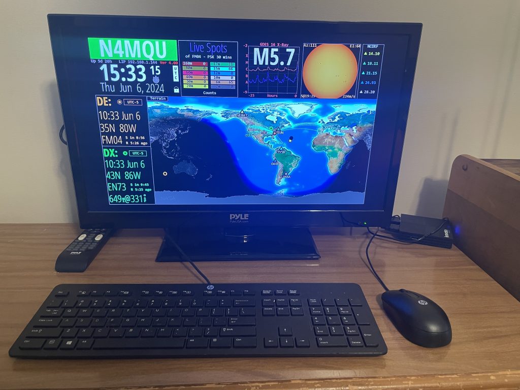 Computer monitor and keyboard showing an amateur radio signal propagation map.