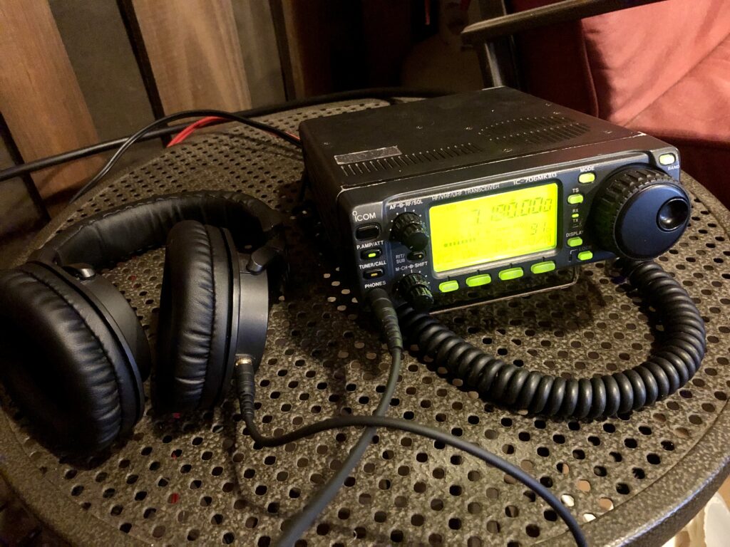 iCom 706 mark two G amateur radio next to a set up headphones